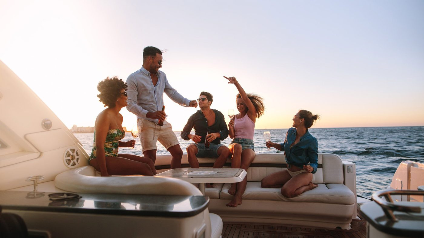Guests on a private boat at sunset along the Amalfi Coast